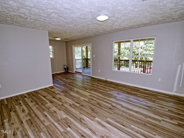 empty room featuring hardwood / wood-style floors and a textured ceiling