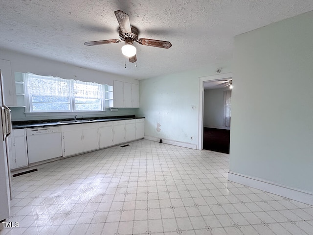 kitchen featuring light tile patterned floors, dishwasher, white cabinetry, ceiling fan, and sink