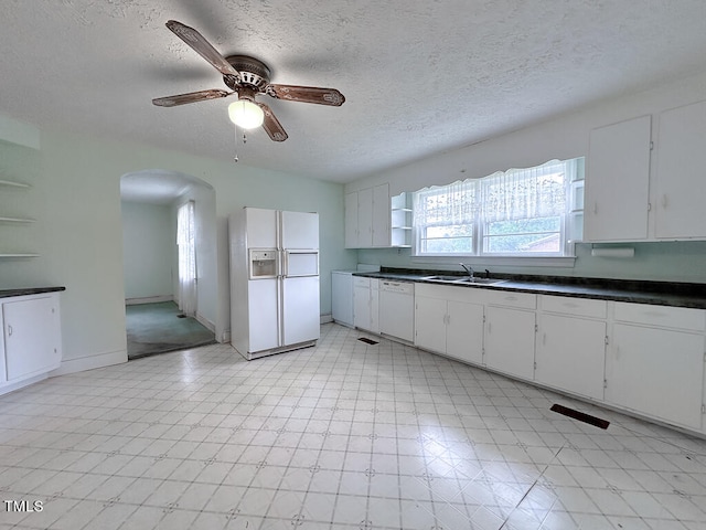 kitchen featuring ceiling fan, white cabinetry, light tile patterned floors, white appliances, and sink