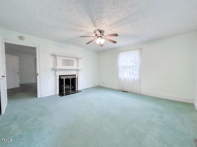 unfurnished living room featuring a textured ceiling, carpet, and ceiling fan