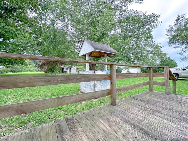 deck with a shed and a yard