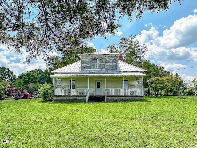 exterior space featuring covered porch and a front lawn