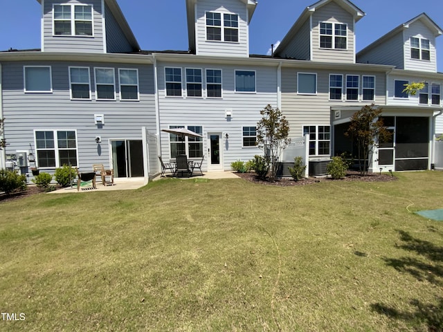 rear view of house with central AC, a yard, and a patio area