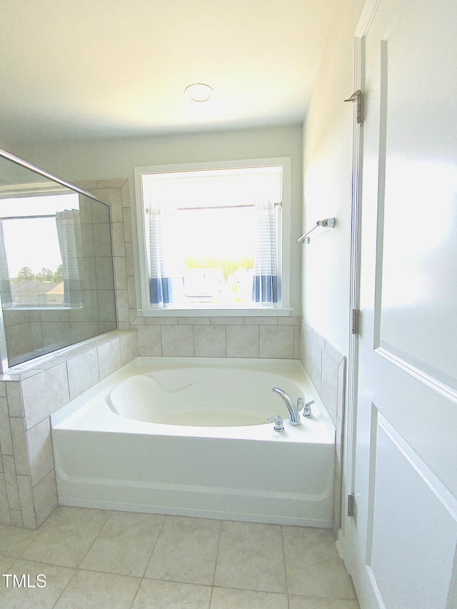 bathroom featuring tile patterned floors and a bathing tub