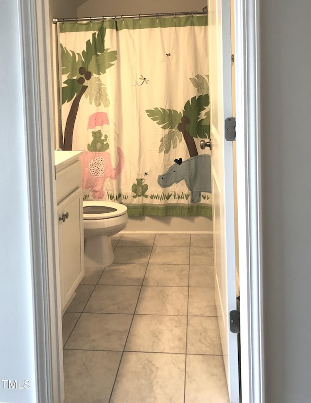 full bathroom featuring vanity, shower / tub combo with curtain, tile patterned floors, and toilet