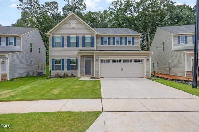 view of front of house with a garage and a front lawn