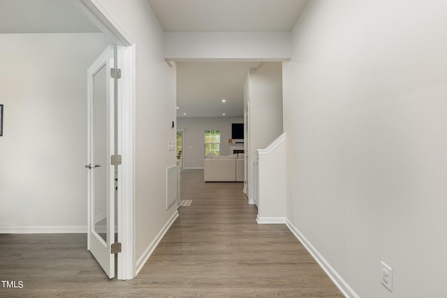 corridor featuring visible vents, baseboards, wood finished floors, and recessed lighting