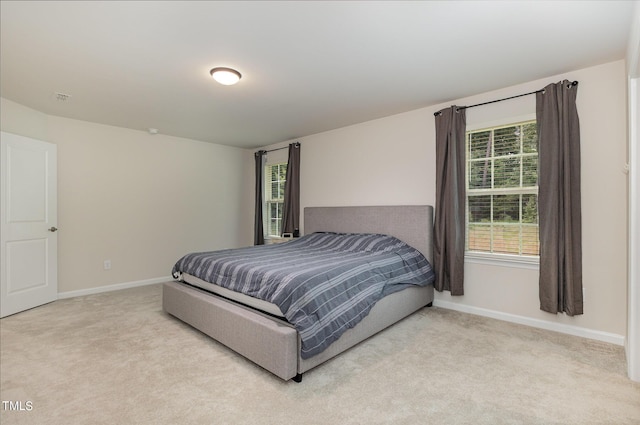 bedroom with carpet, visible vents, and baseboards