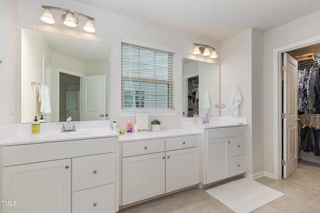 bathroom featuring two vanities, a sink, and tile patterned floors