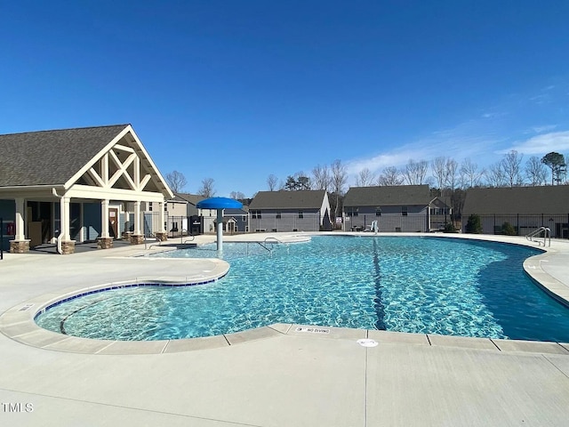 pool featuring a patio and fence