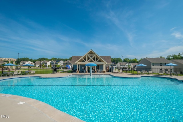 pool featuring a patio area, a residential view, and fence