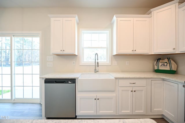 kitchen with white cabinetry, light stone countertops, sink, and stainless steel dishwasher