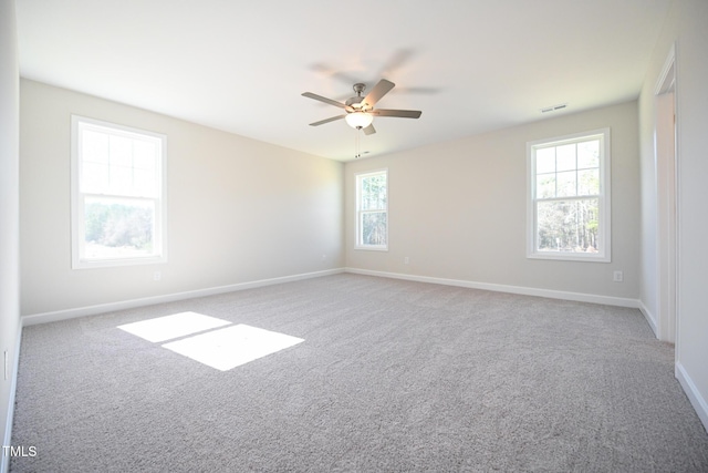 unfurnished room featuring light colored carpet and ceiling fan