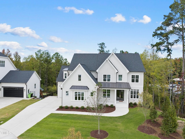 modern farmhouse style home featuring a garage and a front yard