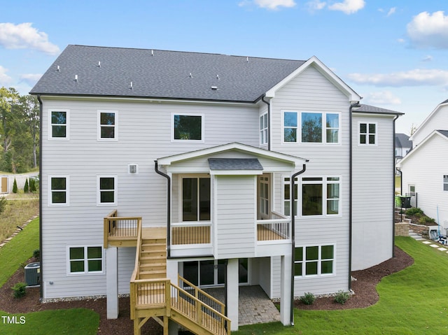 rear view of house with a yard, a sunroom, cooling unit, and a deck