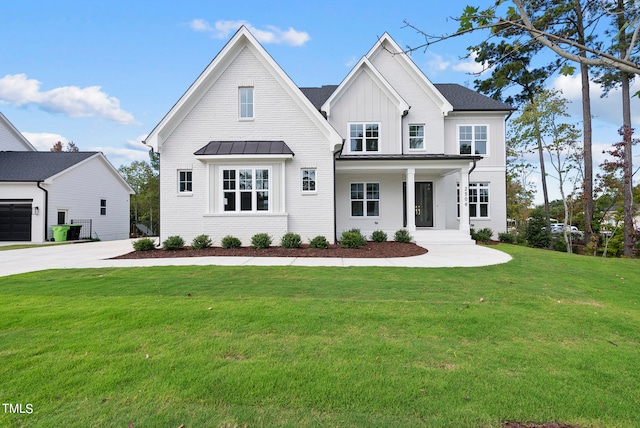 modern farmhouse featuring a garage and a front lawn