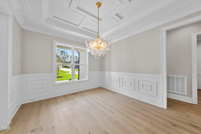 unfurnished dining area featuring a notable chandelier, crown molding, and light hardwood / wood-style floors