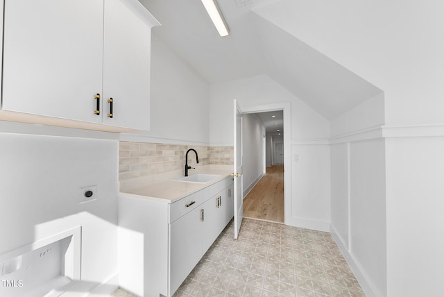 washroom with cabinets, sink, and hookup for an electric dryer