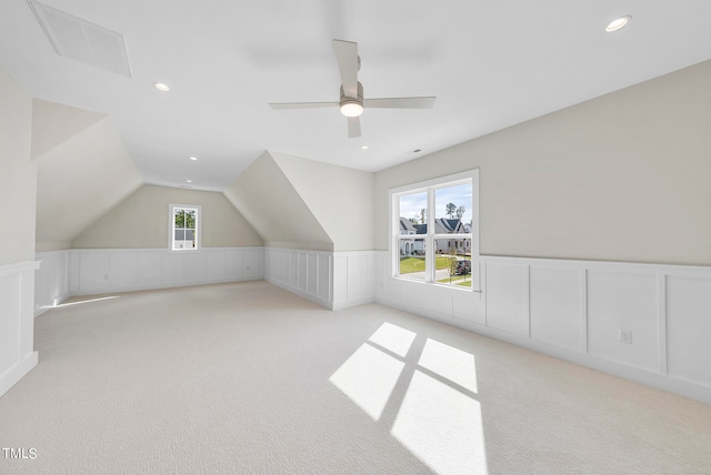 additional living space featuring lofted ceiling, ceiling fan, and light carpet