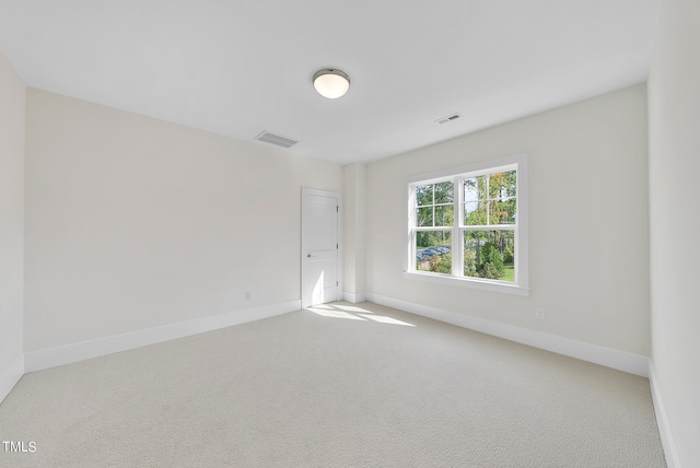 unfurnished room with light carpet