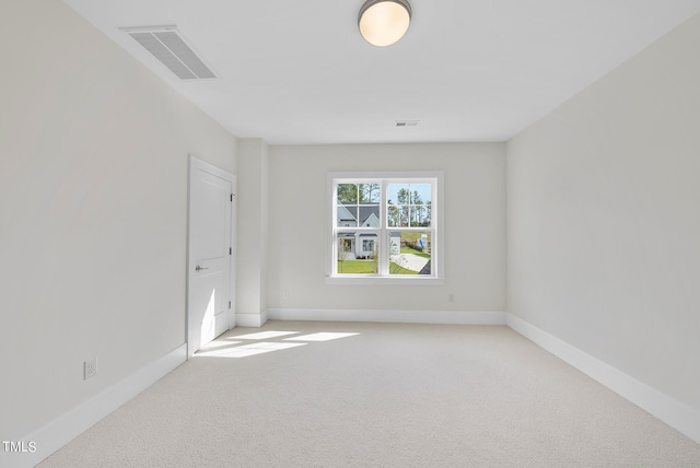 empty room featuring light carpet