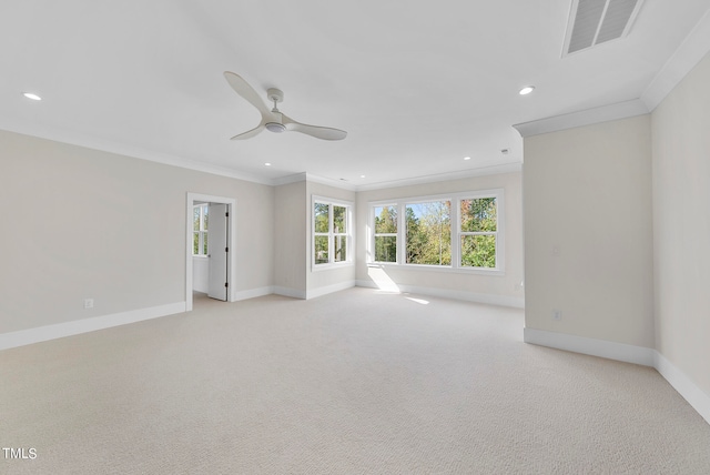 spare room featuring light carpet, ornamental molding, and ceiling fan