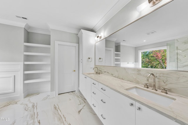 bathroom featuring built in features, ornamental molding, and vanity