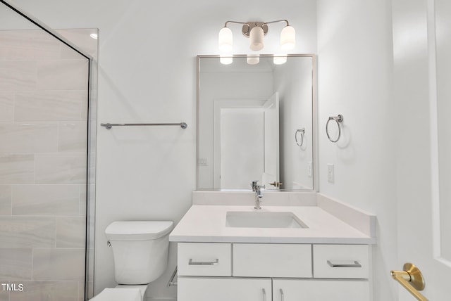 bathroom with an enclosed shower, vanity, and toilet