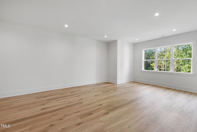 spare room featuring light hardwood / wood-style flooring