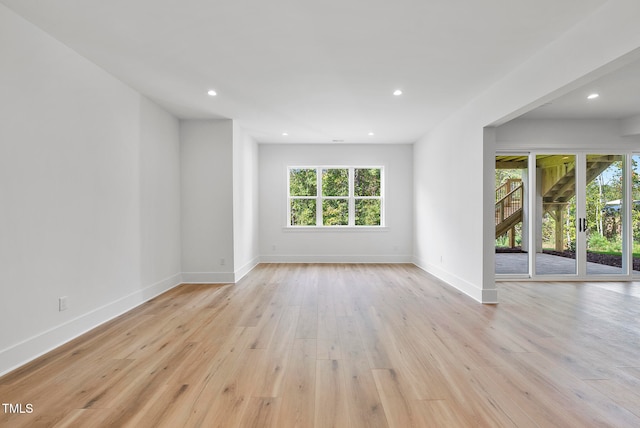 empty room featuring french doors and light hardwood / wood-style floors