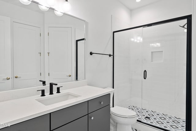 bathroom with walk in shower, vanity, and toilet