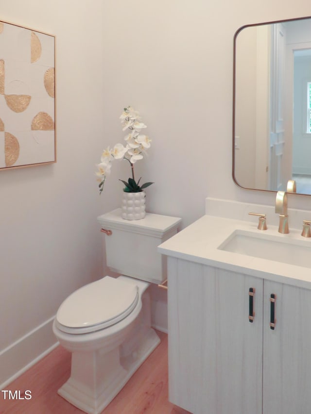2506 Silas Peak Ln, Apex, NC 27523 - half bath featuring vanity, toilet, wood finished floors, and baseboards