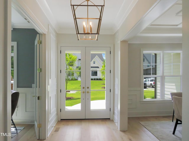 2506 Silas Peak Ln, Apex, NC 27523 - entrance foyer featuring french doors, plenty of natural light, light wood-style flooring, a decorative wall, and crown molding