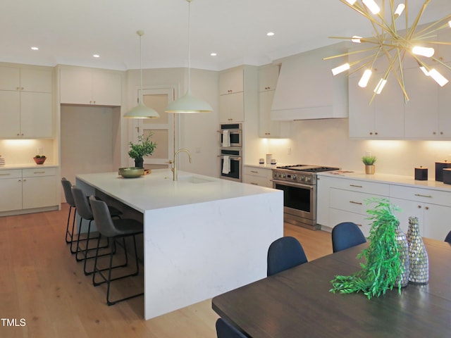 2506 Silas Peak Ln, Apex, NC 27523 - kitchen featuring a sink, stainless steel appliances, light wood finished floors, a kitchen breakfast bar, and white cabinetry