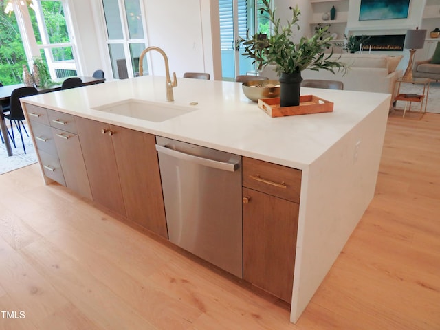 2506 Silas Peak Ln, Apex, NC 27523 - kitchen featuring stainless steel dishwasher, a sink, light wood finished floors, and healthy amount of natural light