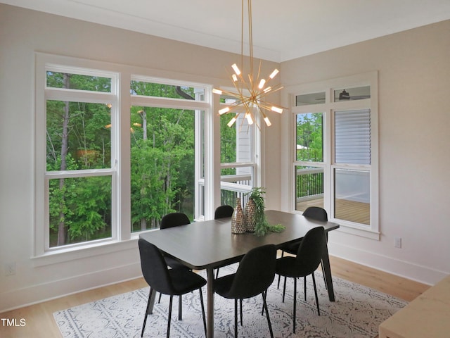 2506 Silas Peak Ln, Apex, NC 27523 - dining space featuring a chandelier, healthy amount of natural light, light wood finished floors, and baseboards