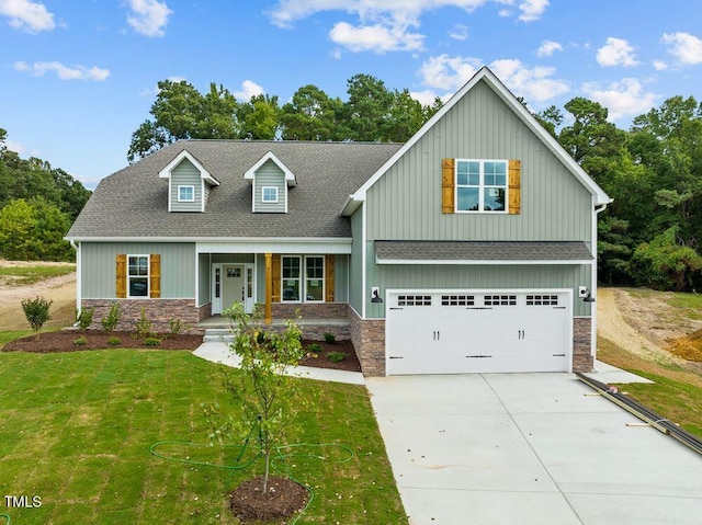 view of front facade with a front yard and a garage