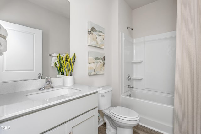 full bathroom featuring toilet, hardwood / wood-style flooring, bathtub / shower combination, and vanity