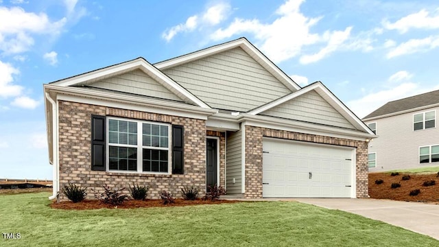 view of front of house with a front lawn, an attached garage, and driveway