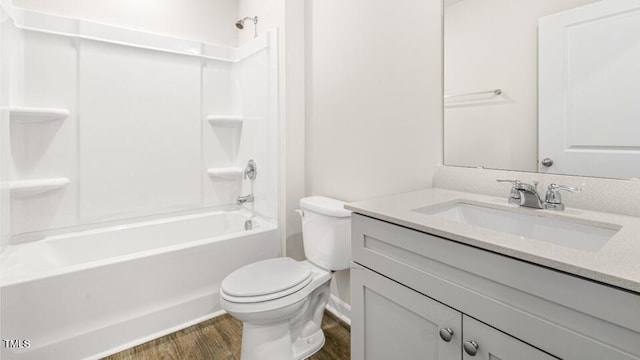 full bathroom with tub / shower combination, toilet, wood finished floors, and vanity