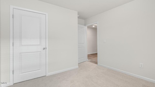 unfurnished bedroom featuring carpet flooring and baseboards