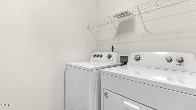 washroom with washer and clothes dryer and laundry area