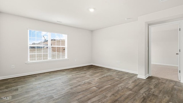 empty room with wood finished floors and baseboards