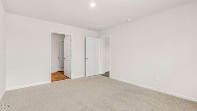 unfurnished bedroom featuring baseboards and carpet floors