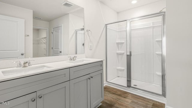 full bathroom with visible vents, a stall shower, and a sink