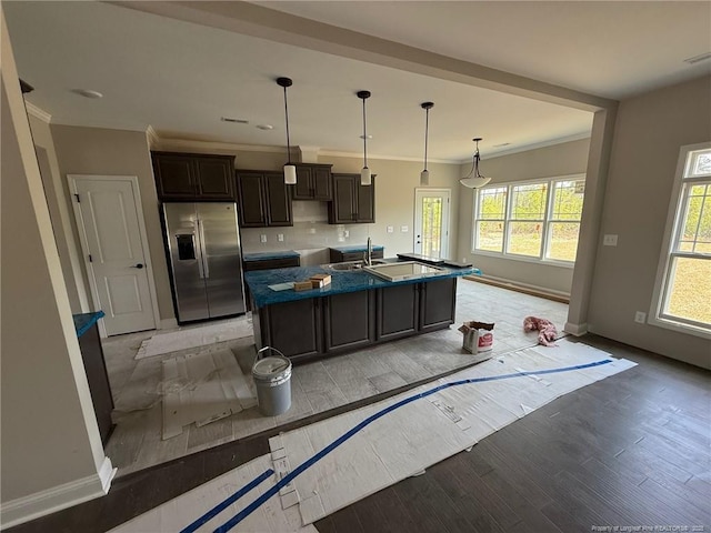 3013 Deeside Ct, Fayetteville, NC 28306 - kitchen with light wood finished floors, stainless steel fridge with ice dispenser, crown molding, a center island with sink, and baseboards