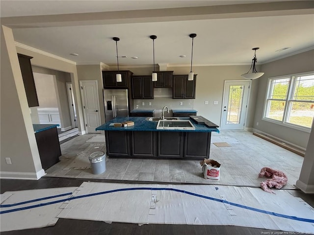 3013 Deeside Ct, Fayetteville, NC 28306 - kitchen with a kitchen island with sink, baseboards, a sink, and stainless steel fridge with ice dispenser