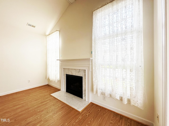 4712 Fox Fern Ln, Raleigh, NC 27604 - unfurnished living room with wood finished floors, a fireplace, vaulted ceiling, and baseboards
