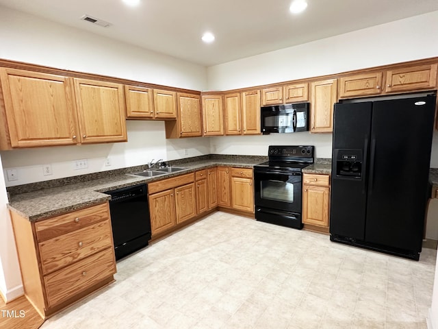 4712 Fox Fern Ln, Raleigh, NC 27604 - kitchen featuring black appliances, a sink, dark countertops, recessed lighting, and light flooring