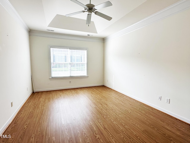 4712 Fox Fern Ln, Raleigh, NC 27604 - empty room featuring wood finished floors, ornamental molding, a ceiling fan, baseboards, and a tray ceiling